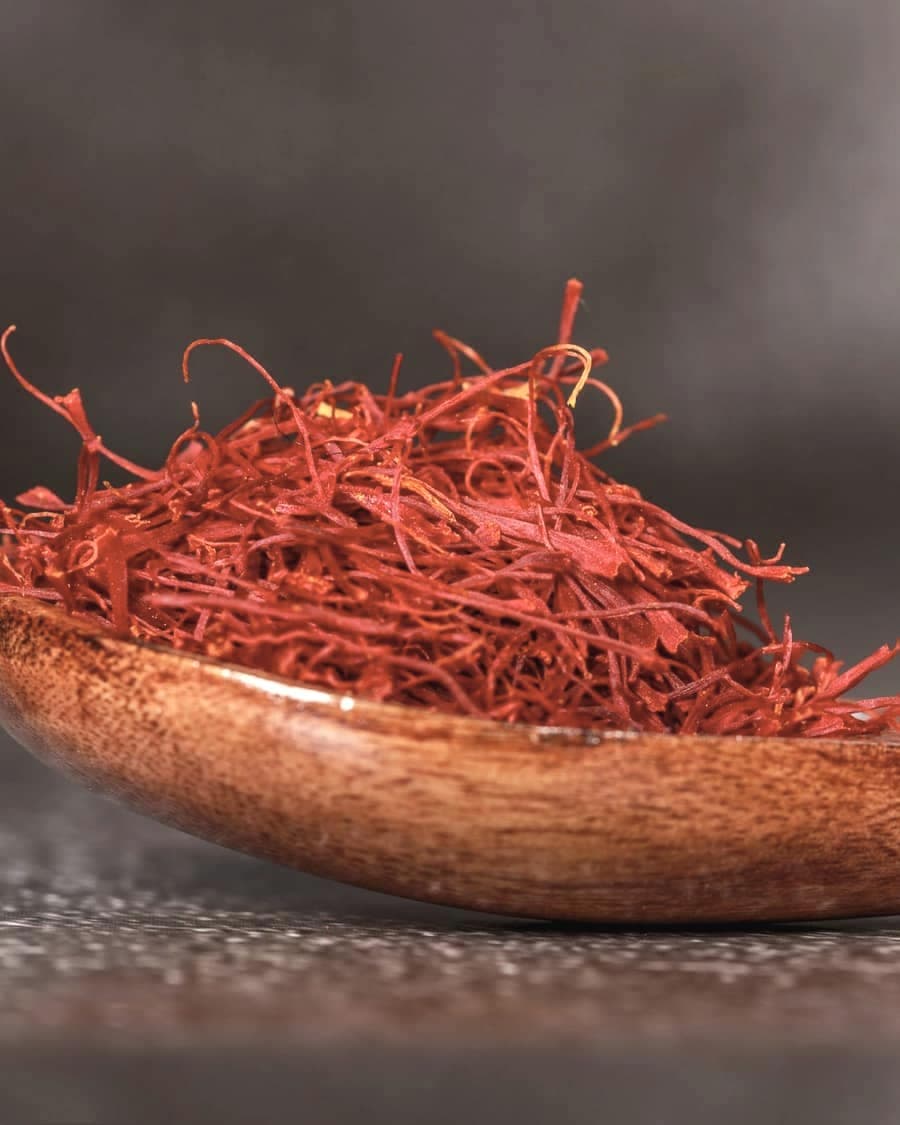 Saffron threads gathered on a wooden spoon